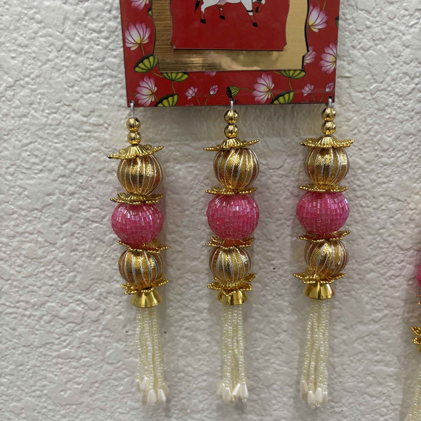 Close-up of Shubh Labh hanging set showing intricate gota and thread work craftsmanship