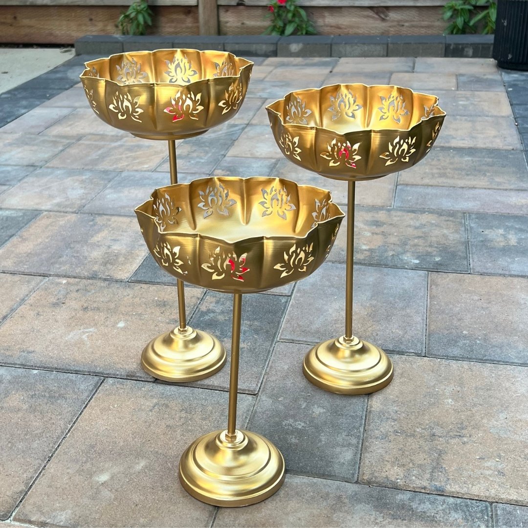 Gold Lotus Motif Urli Set of 3 by Urli Utsav Decor — standing decorative bowls arranged on patio; ideal for wedding aisle decor and festival displays