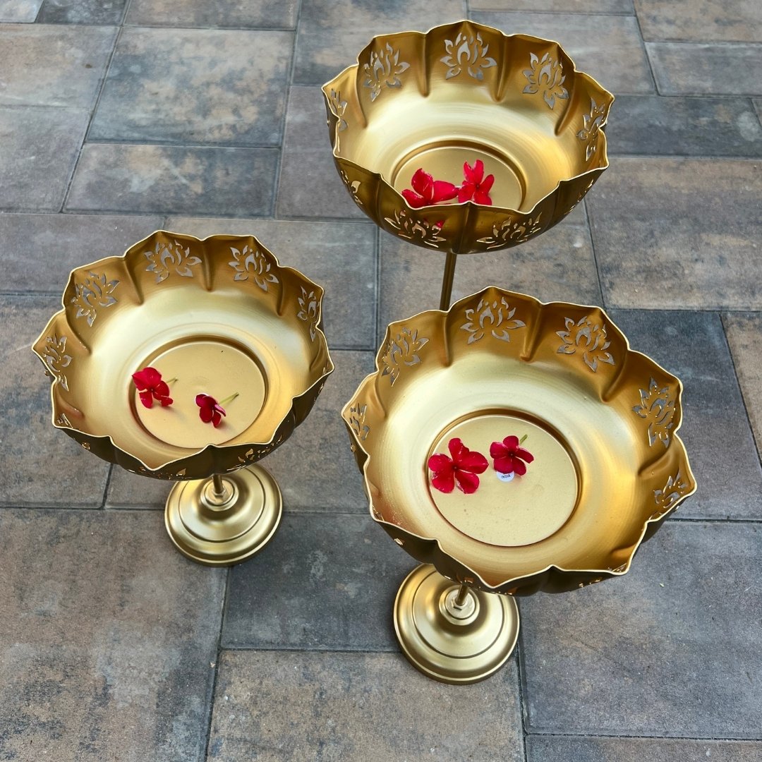 Gold Lotus Motif Urli Set of 3 by Urli Utsav Decor — standing bowls shown with floating flower petals; perfect Diwali, wedding & festive décor