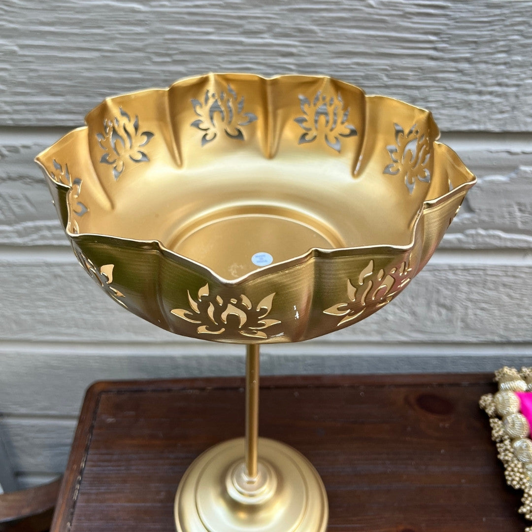Close-up: Gold Lotus Motif cutout and brushed gold finish on standing urli by Urli Utsav Decor — handcrafted iron metal detailing