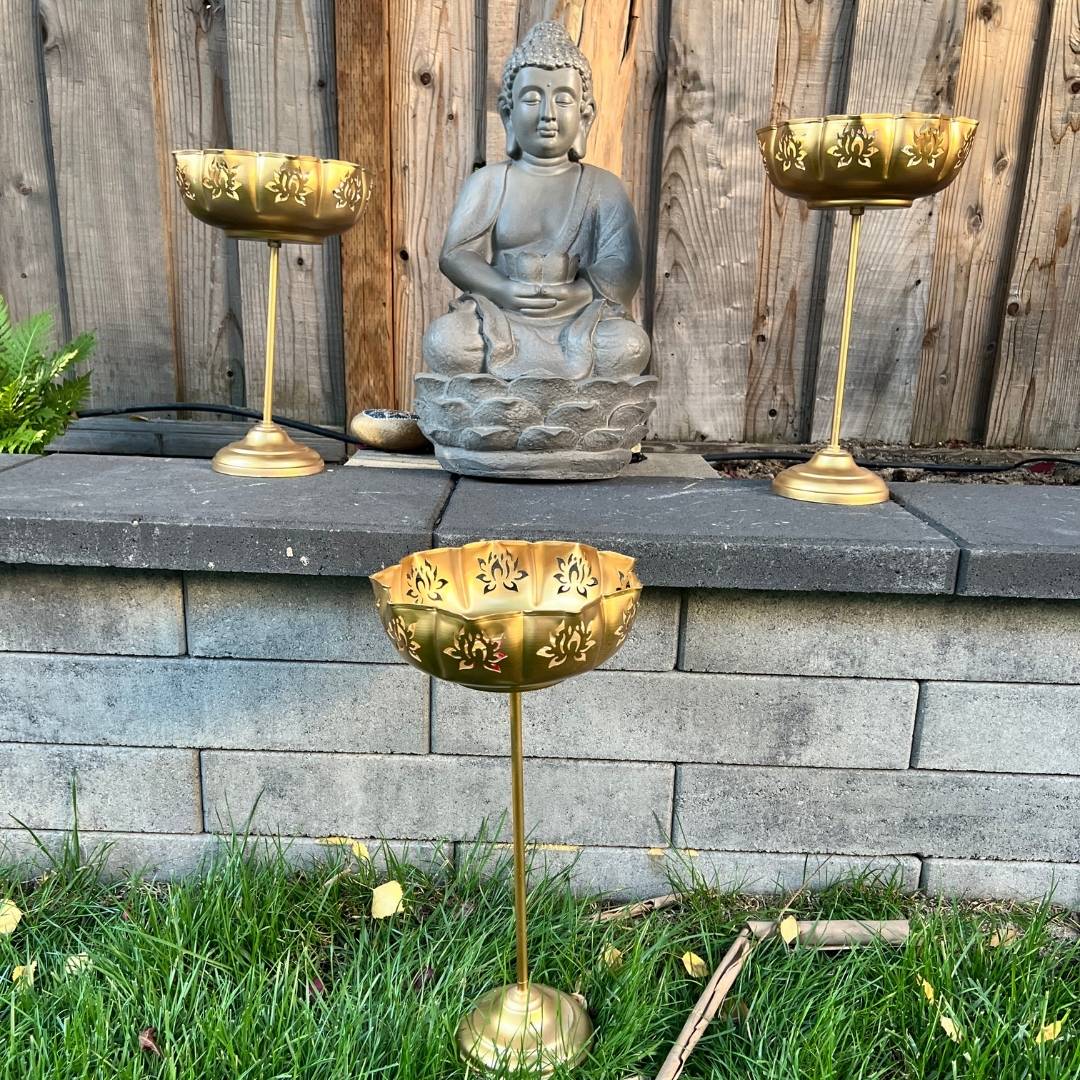 Gold Lotus Motif Urli Set by Urli Utsav Decor — standing bowls styled around Buddha statue for puja, Diwali and meditation corners