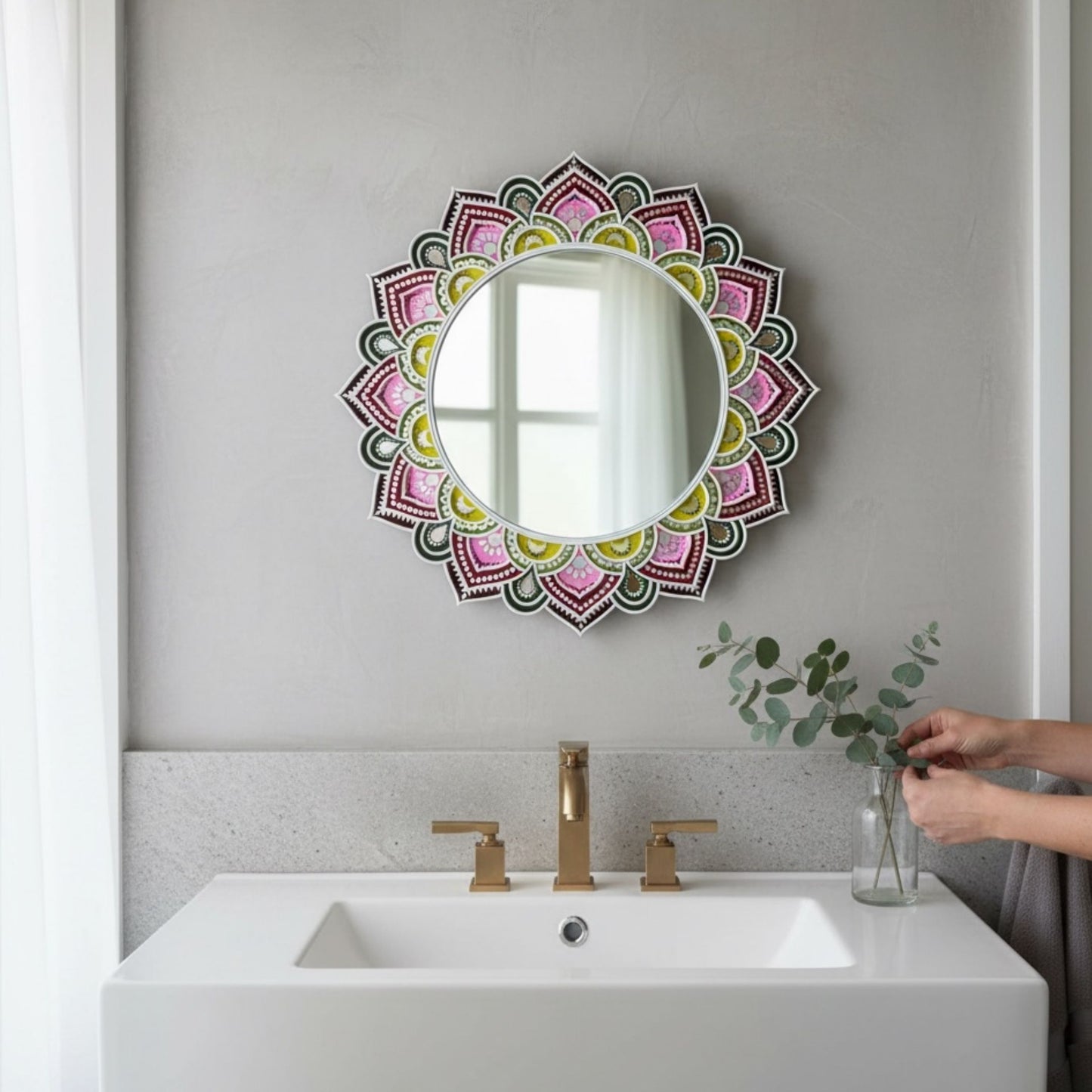 Decorative lippan round mirror with a colorful mandala design above a sink.