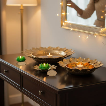 Decorative gold sunflower urli bowls styled as centerpiece décor with reflections
