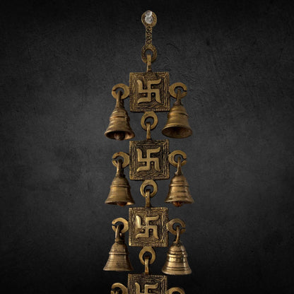A handcrafted 15-inch brass Swastik wall hanging featuring intricate engravings and a polished gold finish, symbolizing prosperity and positive energy