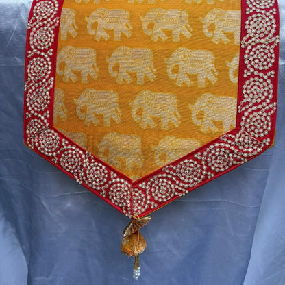Decorative table runner with elephant pattern on a yellow background