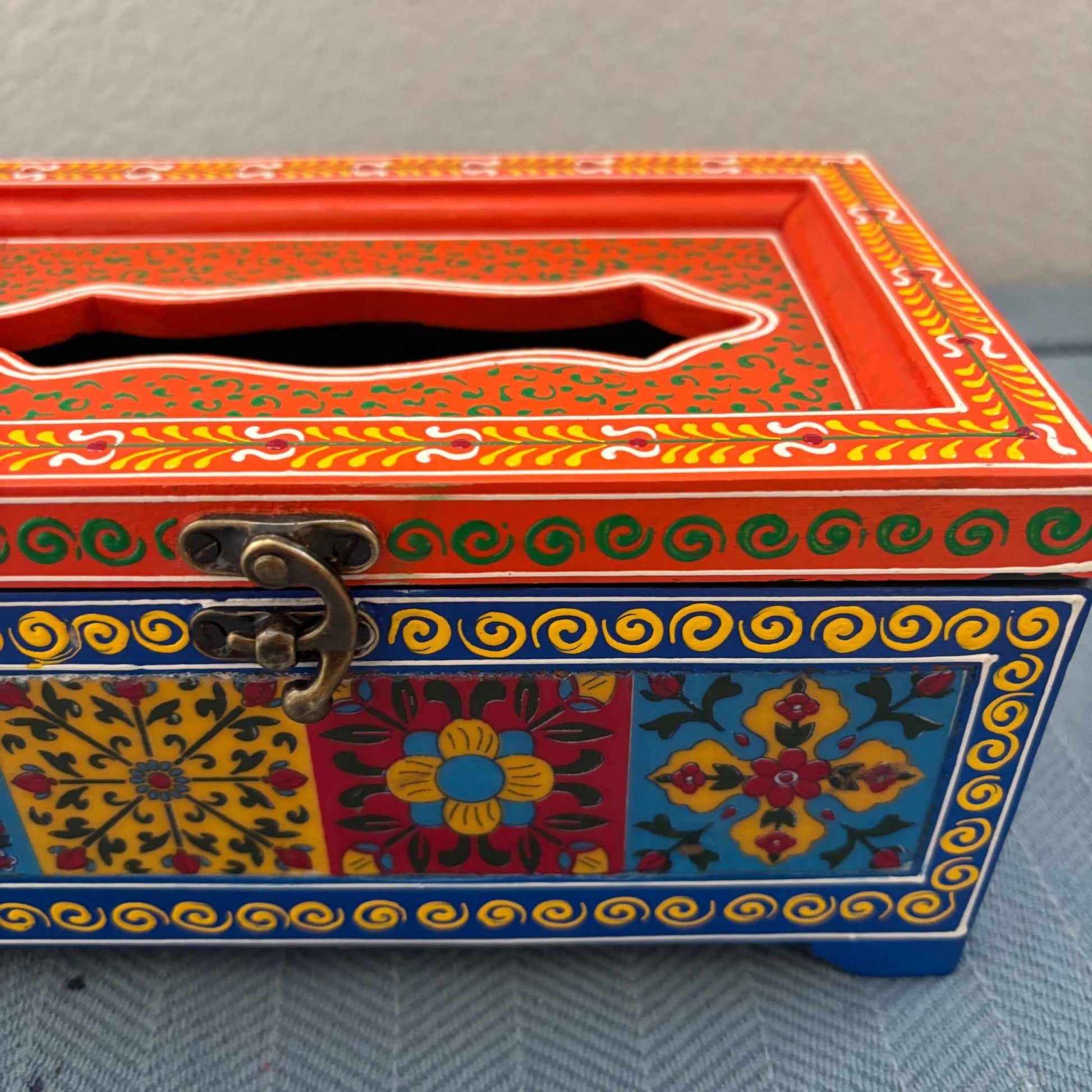 Close-up of blue and red handpainted mango wood tissue box, Rajasthani floral tile detail