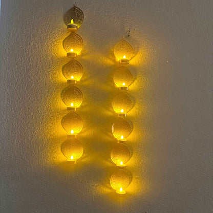 Decorative string lights shaped like a letter 'A' on a white wall.