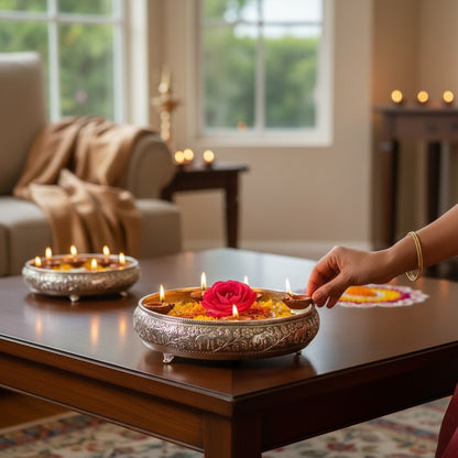 13.5-inch antique silver elephant urli bowl lit for Diwali, with floating diyas around a pink rose on a coffee table