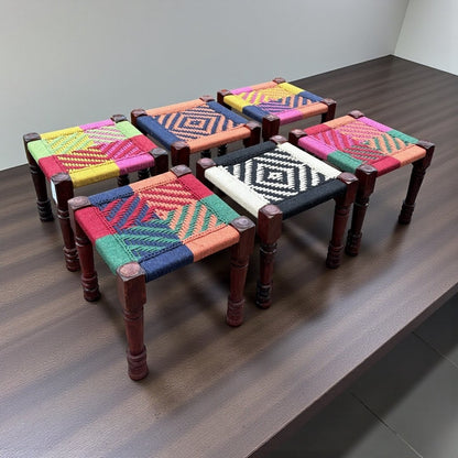 Set of 6 colorful charpai stools from Urli Utsav Decor - Handwoven charpai stool crafted from solid mango wood & cotton rope. A perfect blend of tradition & boho charm for seating, décor, or accent use.