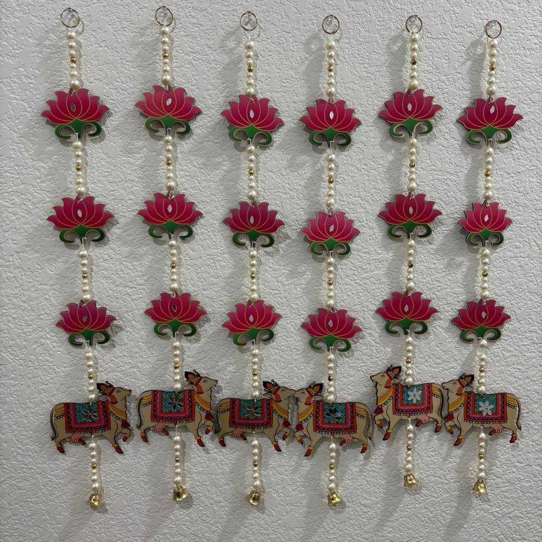 Decorative hanging with pink lotus flowers and colorful animals on a light gray background