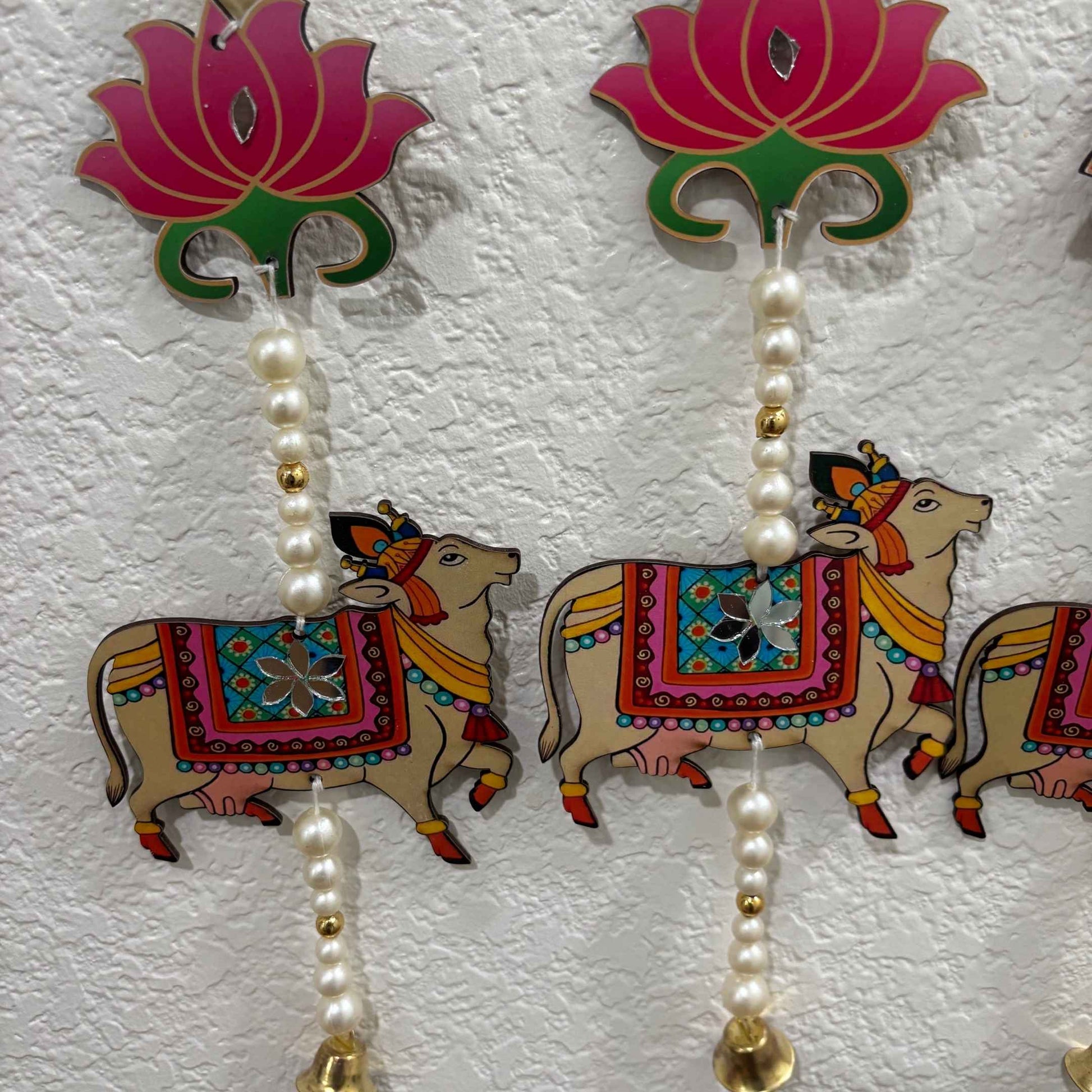 Lotus and cow motif wall hanging for cultural home decor