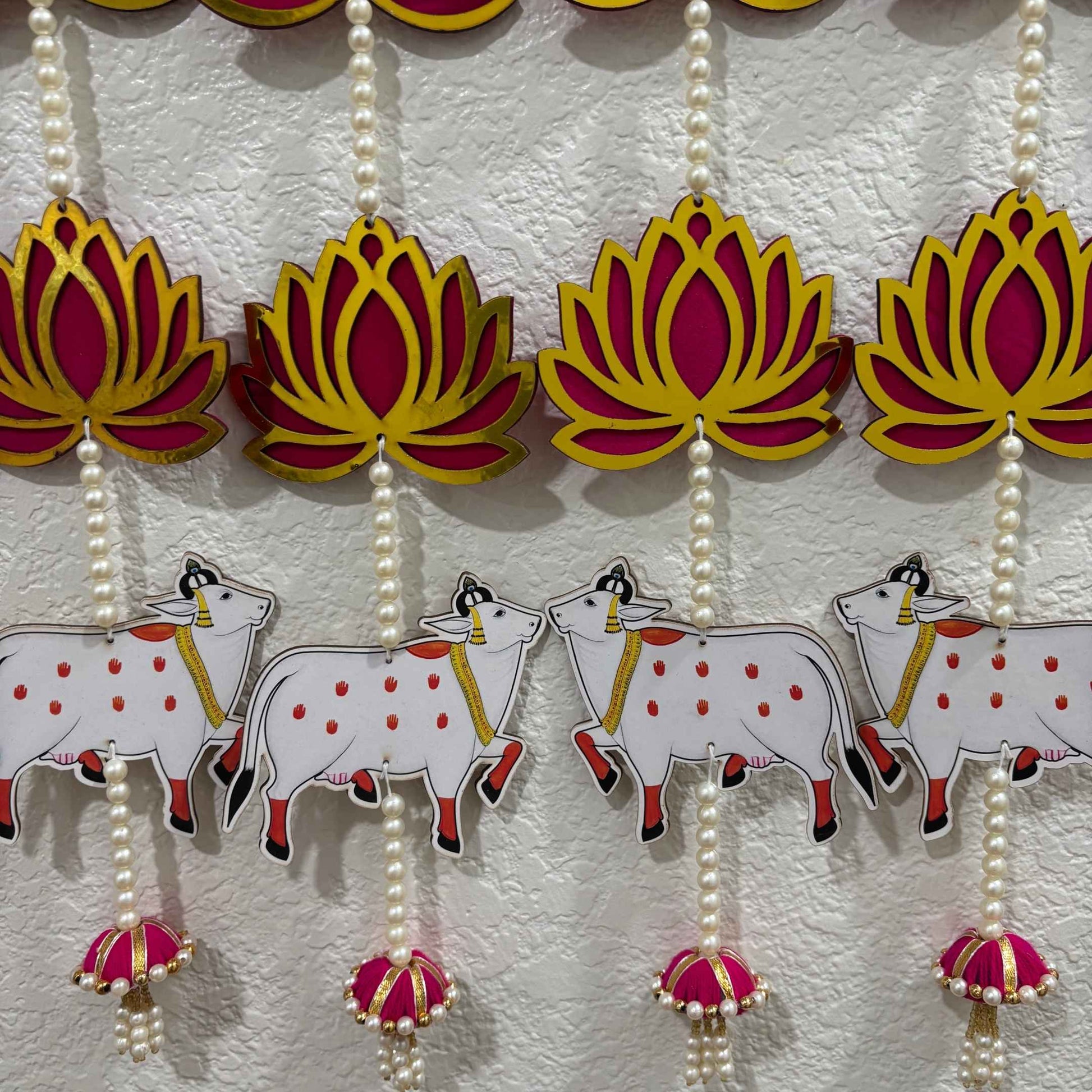 Decorative hanging with lotus flowers and cows on a white background