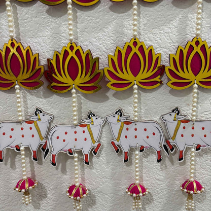 Decorative hanging with lotus flowers and cows on a white background