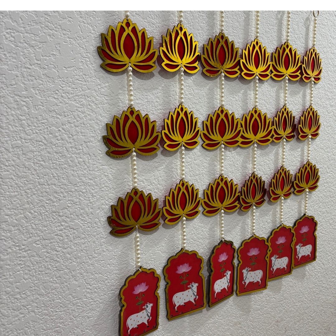Decorative hanging with lotus flowers and animal illustrations on a textured white background