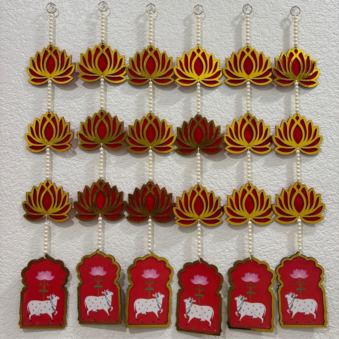 Decorative hanging items with red and gold designs on a white background