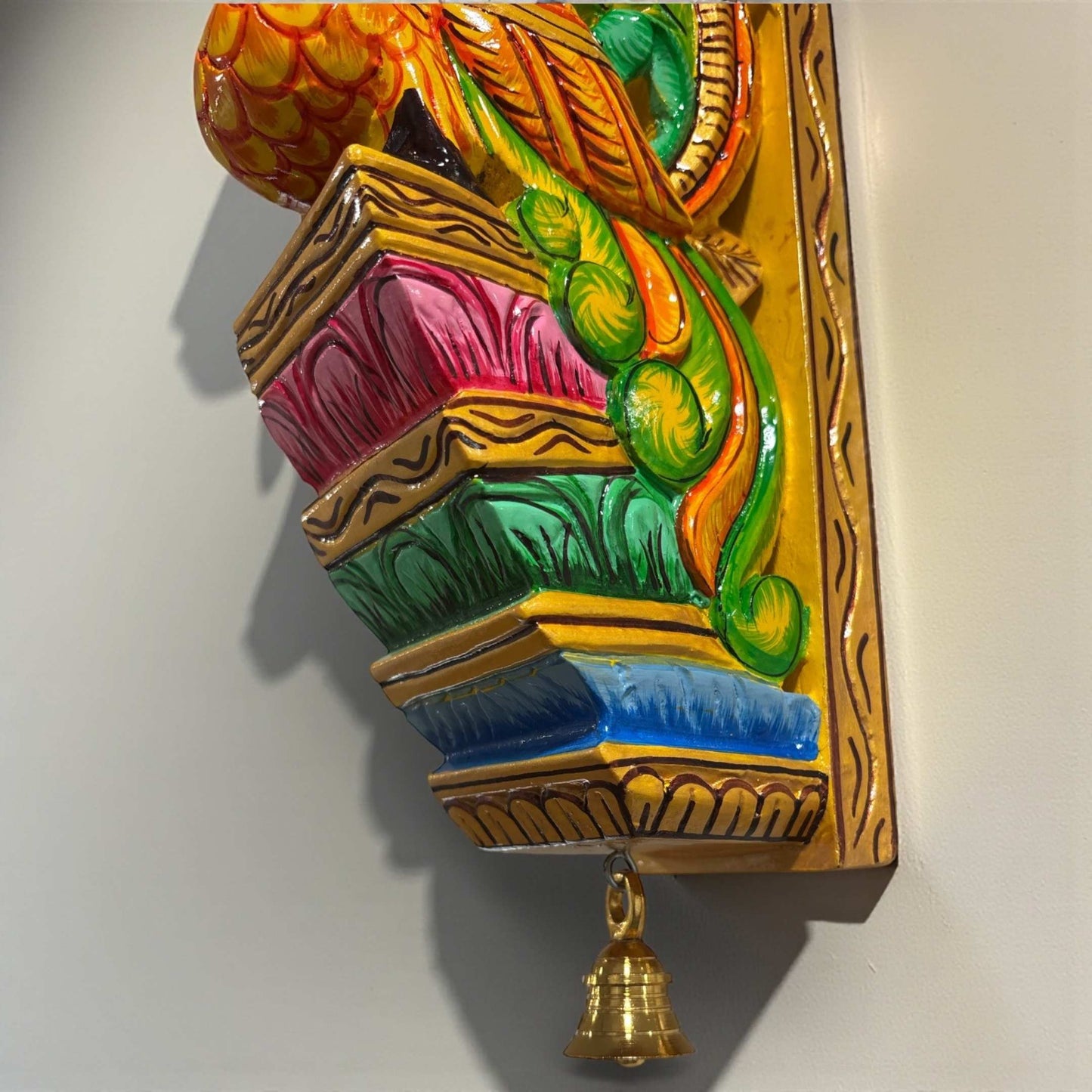 Side profile of a traditional Indian peacock wall bracket carved from a single block of premium mango wood.