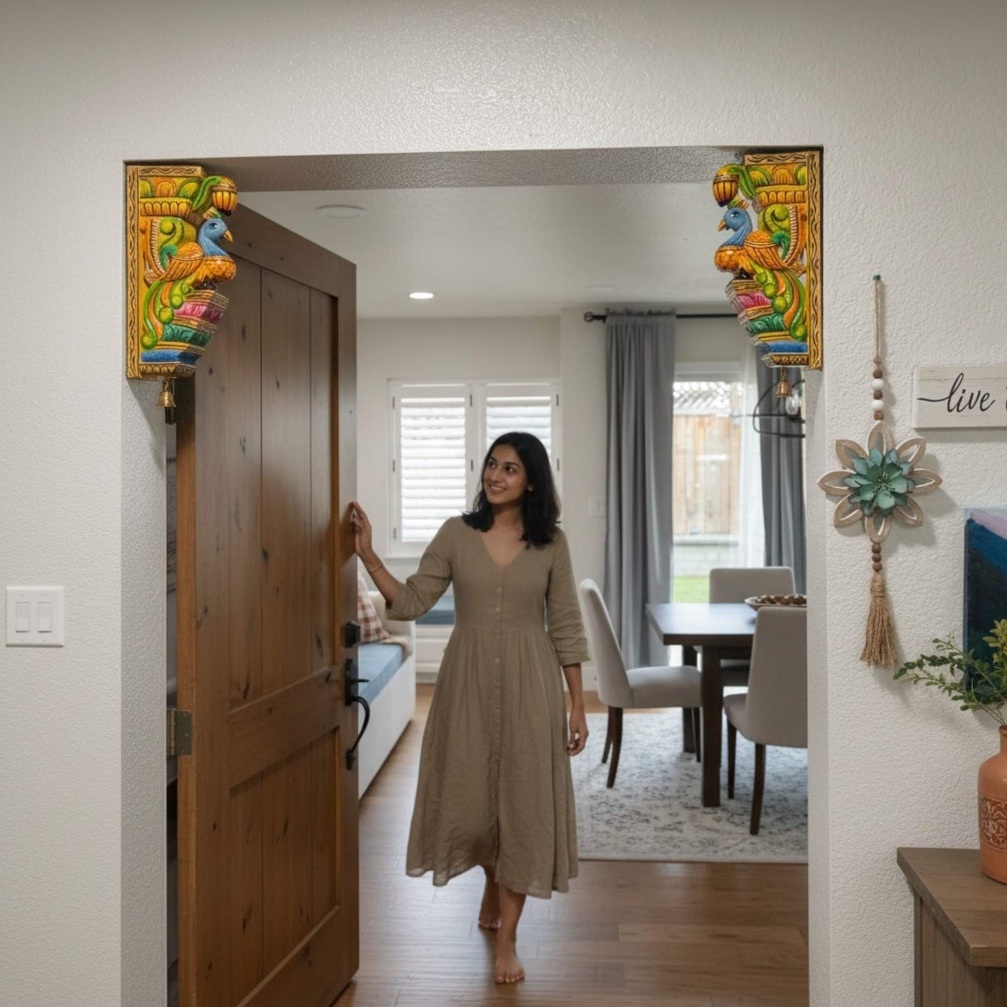 South Indian temple-style wooden elephant corbel used as a decorative doorway accent in a cozy home entryway.