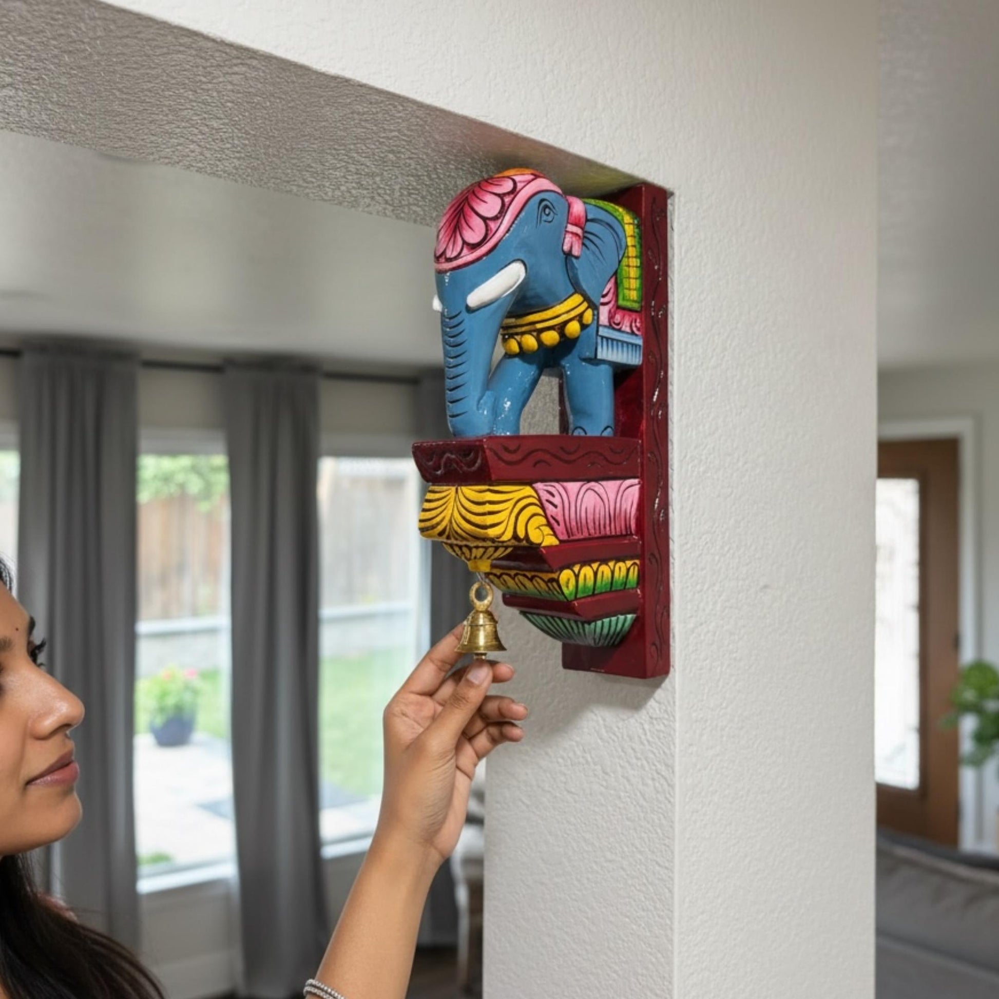 Close-up of the colorful hand-painted elephant design on a South Indian temple-style wooden corbel.