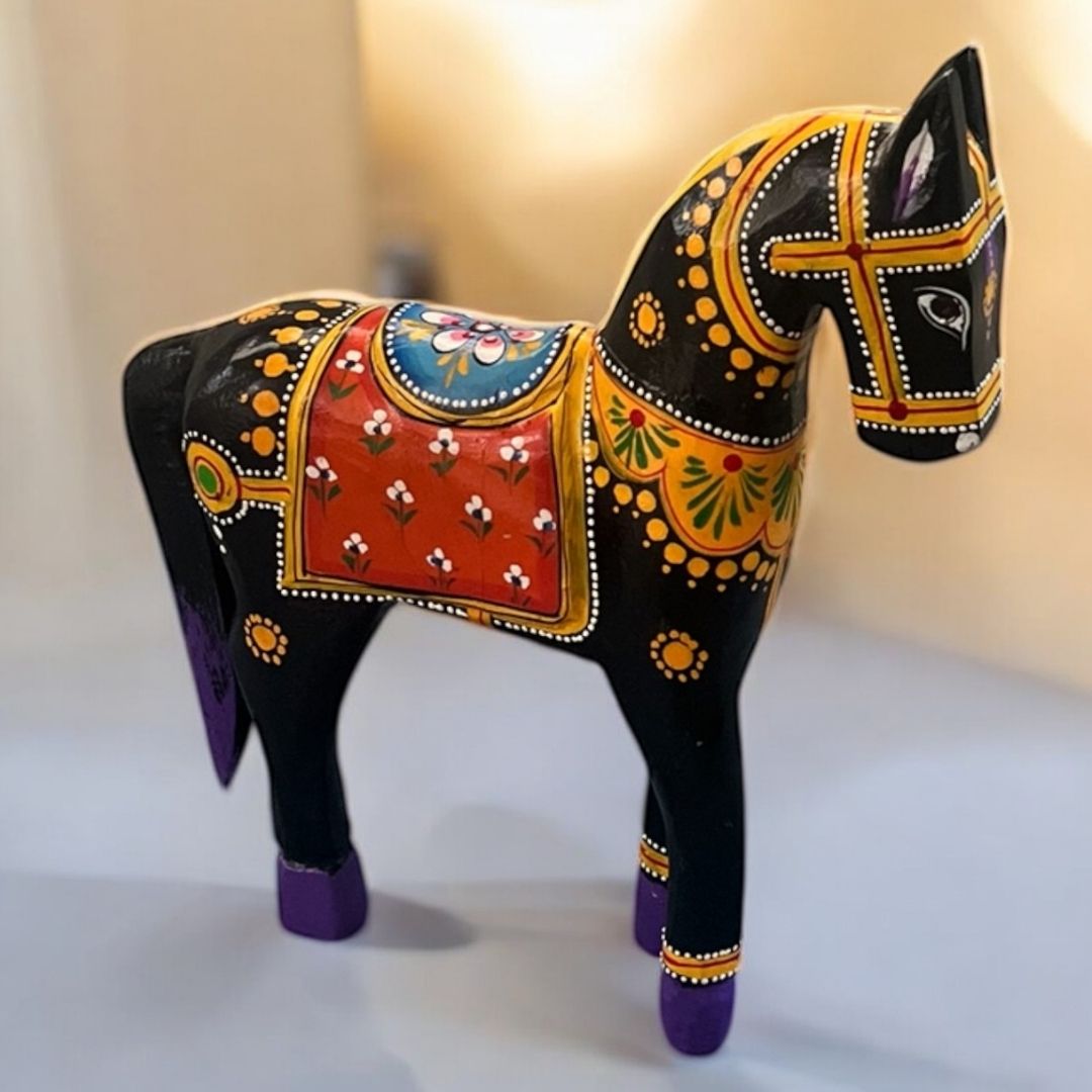 Decorative horse figurine with colorful patterns on a white background